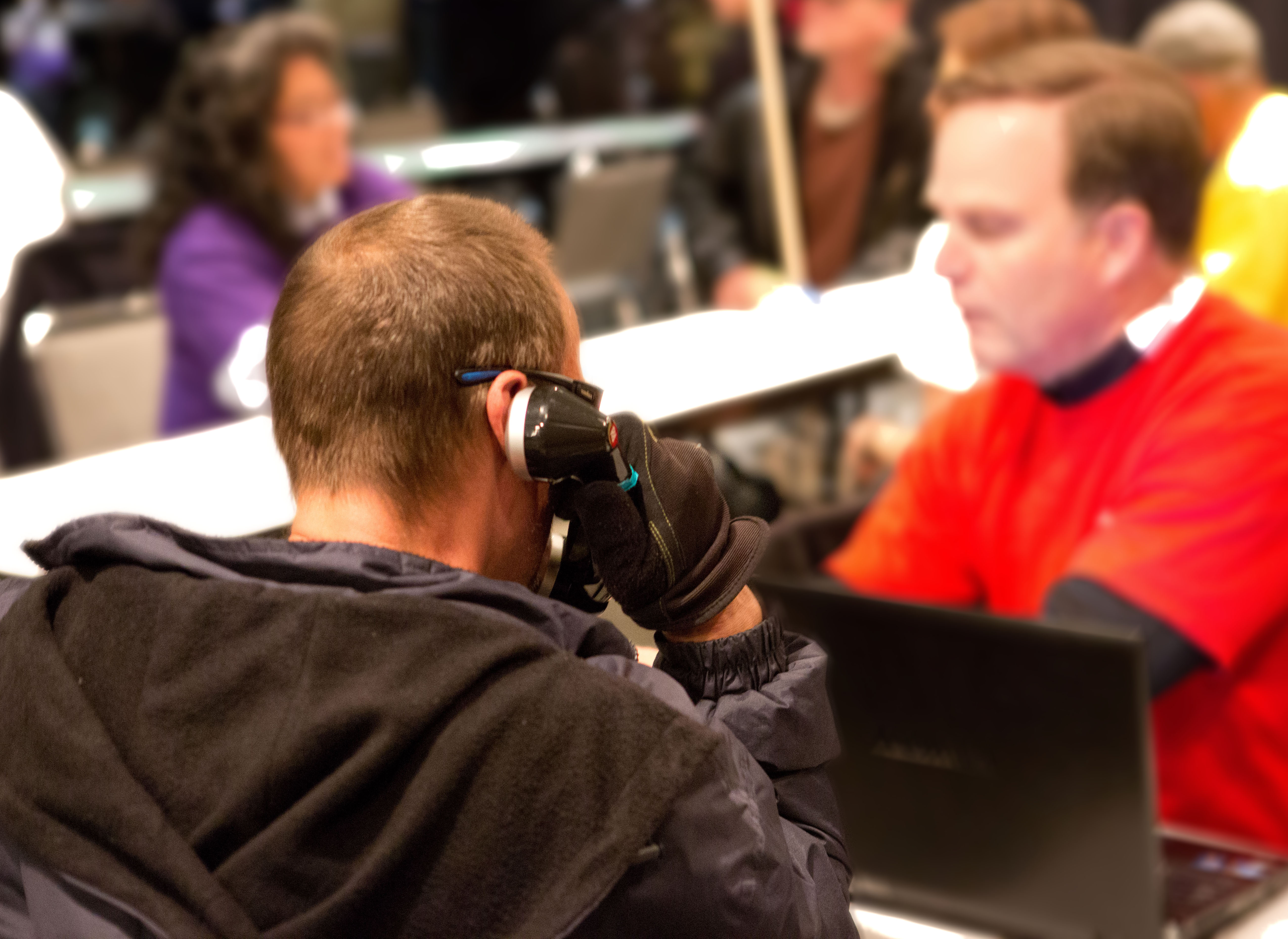 A participant calls a family member during the March 20th Project Homeless Connect event. Photo by Jamey Thomas, 2013